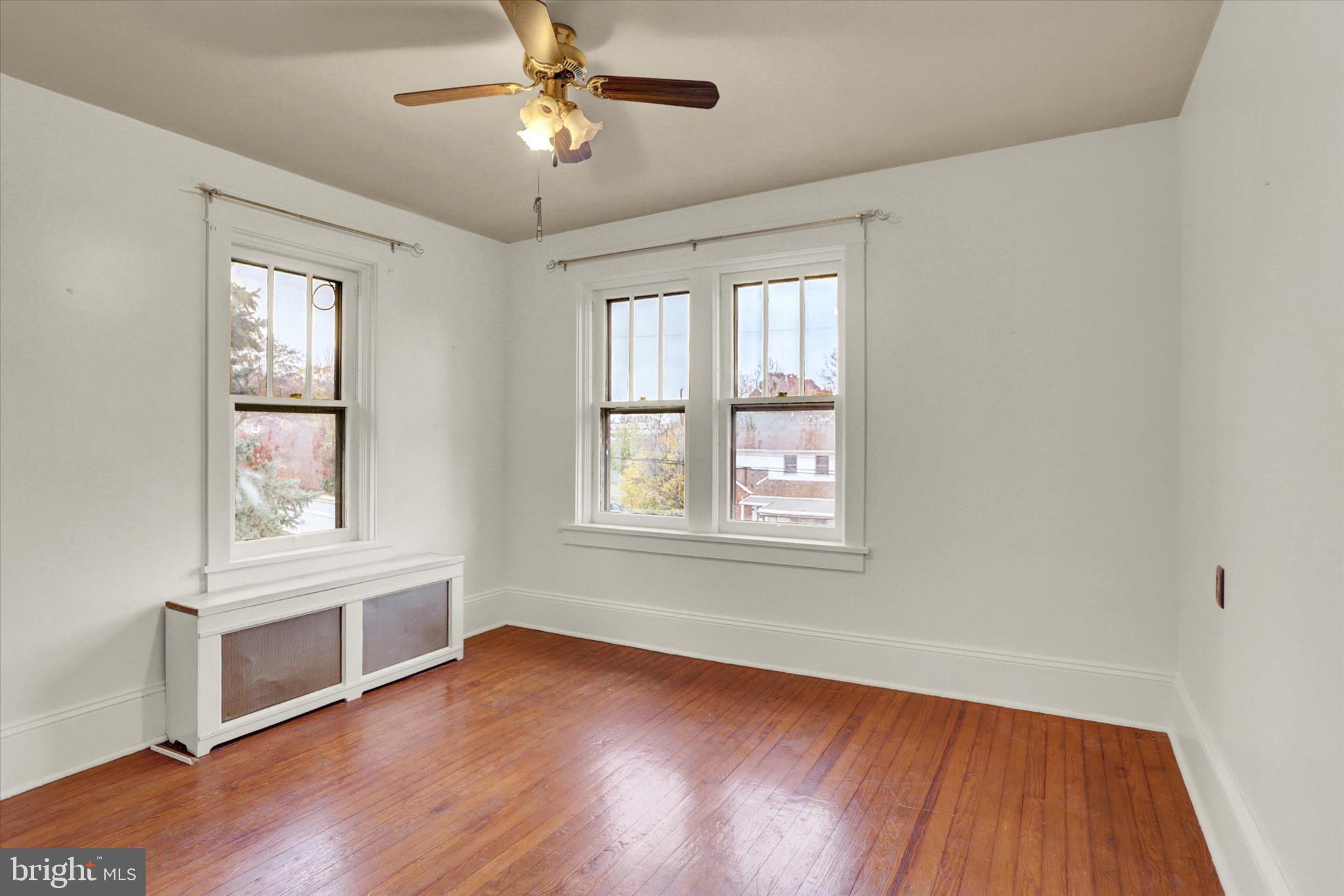 711 Pine Street Steelton, PA 17113 - Photo 17 of 37 a view of an empty room with wooden floor and a window