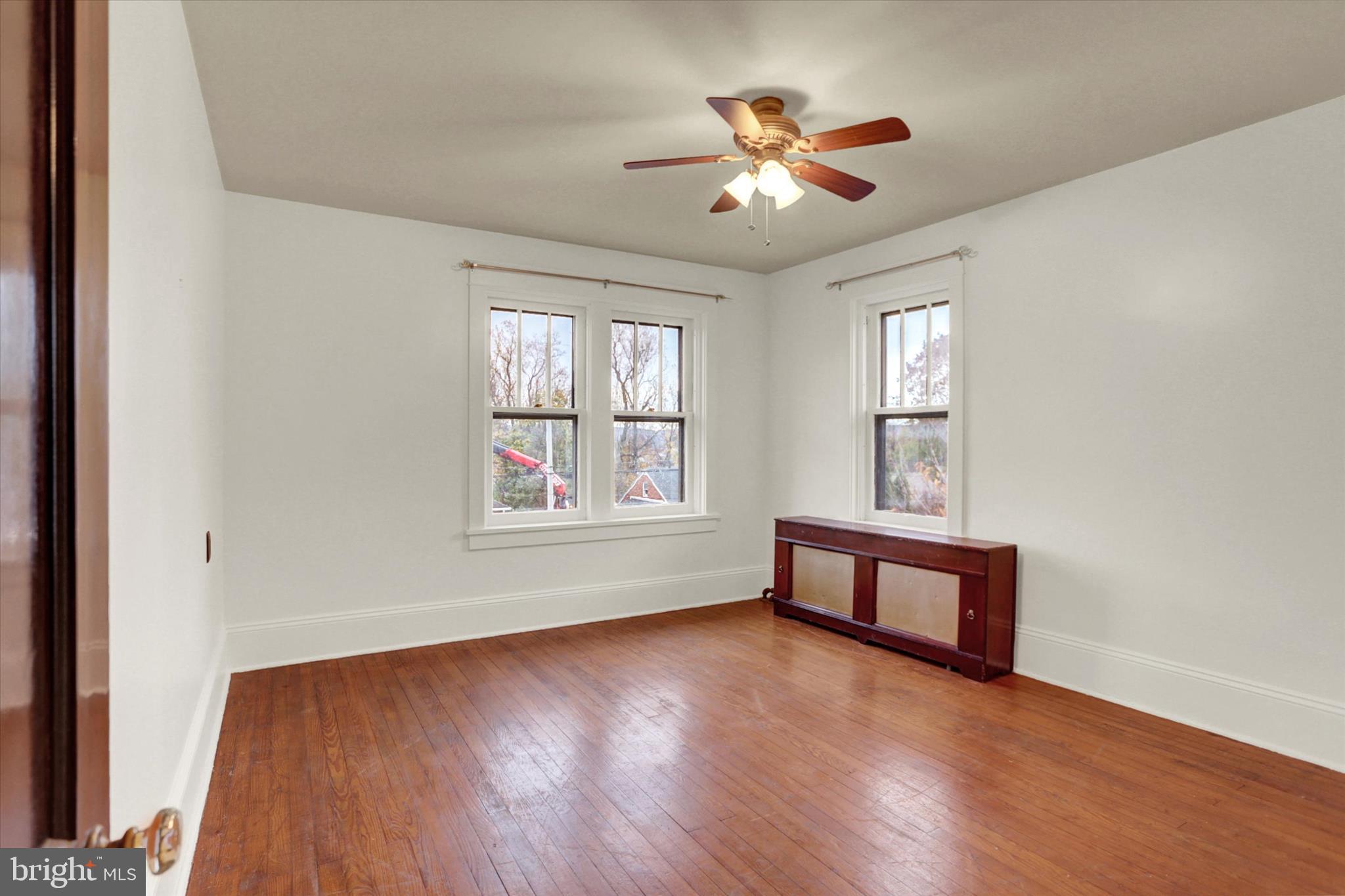711 Pine Street Steelton, PA 17113 - Photo 18 of 37 a view of an empty room with chandelier fan and wooden floor
