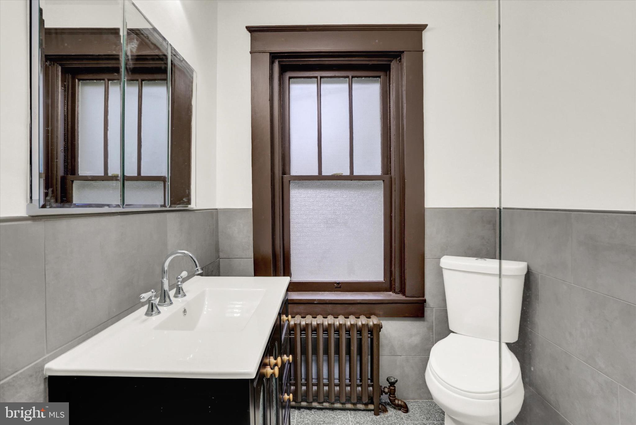 711 Pine Street Steelton, PA 17113 - Photo 24 of 37 a bathroom with a toilet a sink and mirror