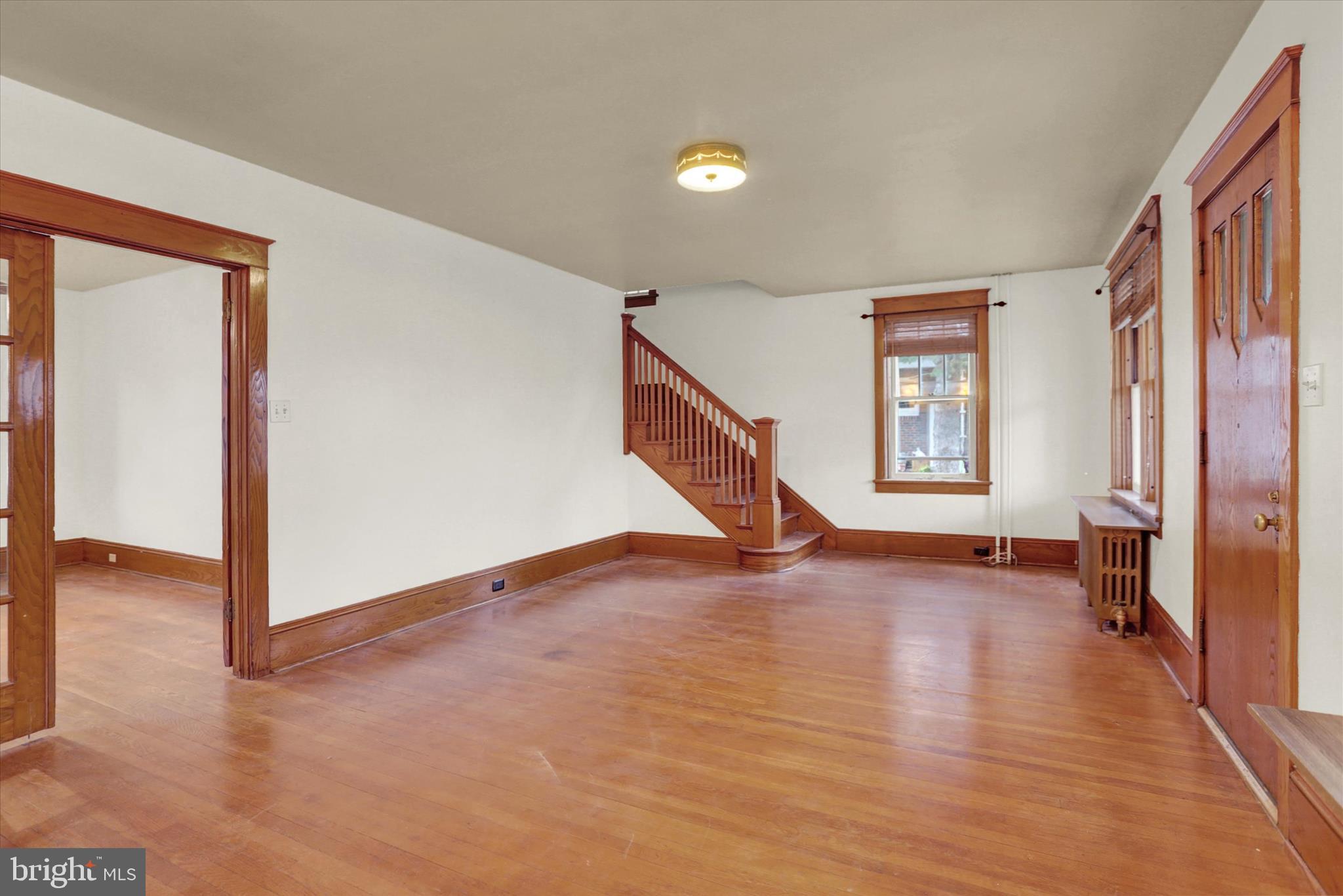 711 Pine Street Steelton, PA 17113 - Photo 8 of 37 a view of an empty room with wooden floor and a window