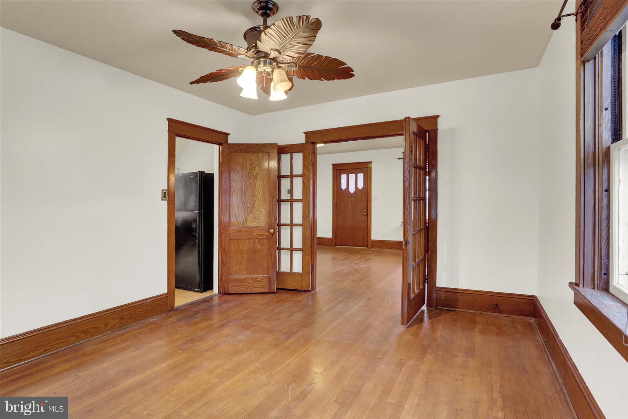 711 Pine Street Steelton, PA 17113 - Photo 9 of 37 a view of an empty room with window and wooden floor