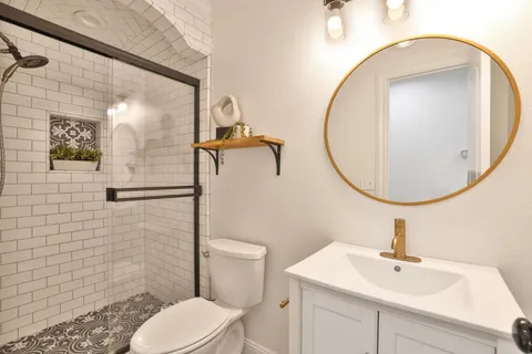 a bathroom with a sink a mirror and a toilet