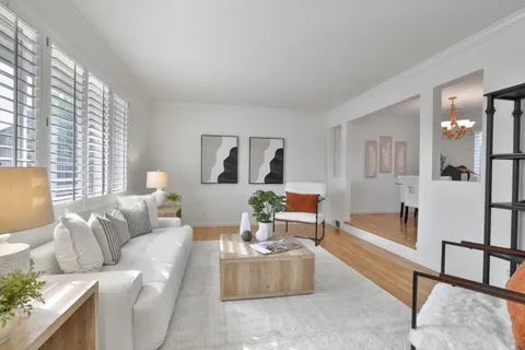 a living room with furniture and a table