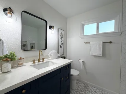 a bathroom with a toilet sink and mirror