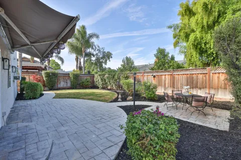 a view of a backyard with sitting area