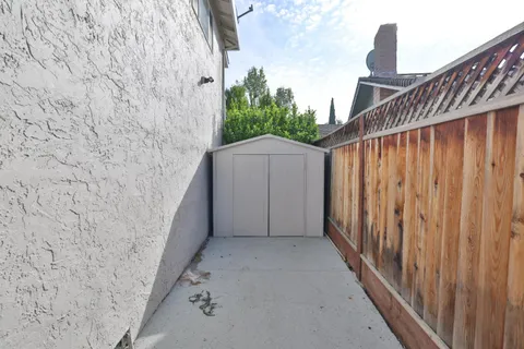 a view of a wooden door with a yard