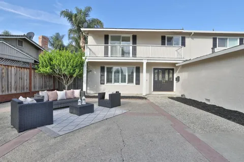 a view of a patio with couches and potted plants