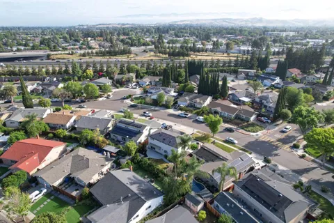 an aerial view of a house with yard swimming pool and lake view