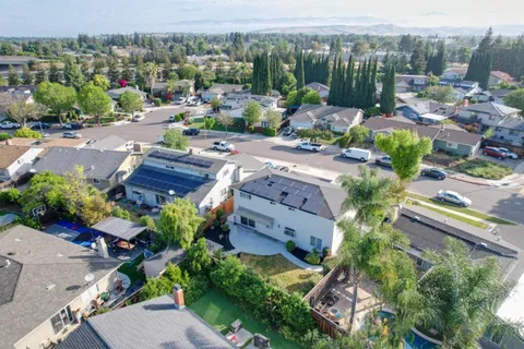 a view of a house with a yard and sitting area