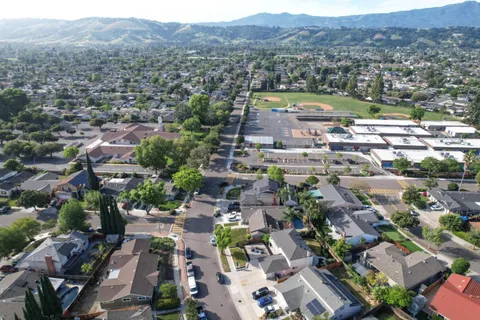 an aerial view of residential house and sandy dunes