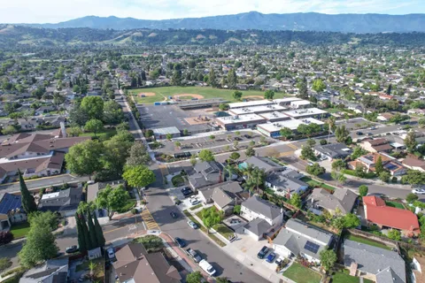 an aerial view of residential house and sandy dunes