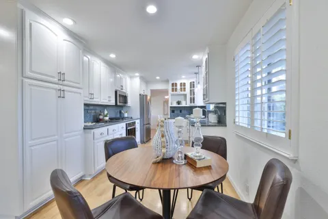 a dining room with kitchen island a table and chairs