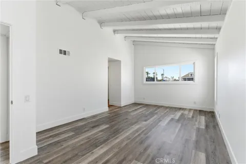 a view of a room with wooden floor