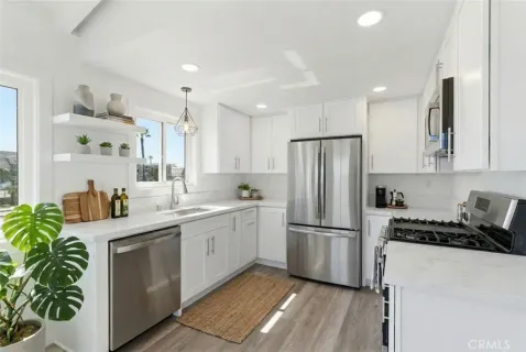 a kitchen with counter top space stainless steel appliances and cabinets