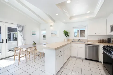 a kitchen with white cabinets and appliances
