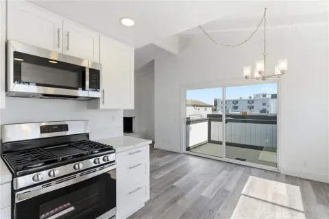 a kitchen with stainless steel appliances granite countertop a stove and a microwave