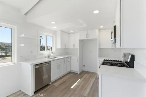 a kitchen with a sink stove and cabinets