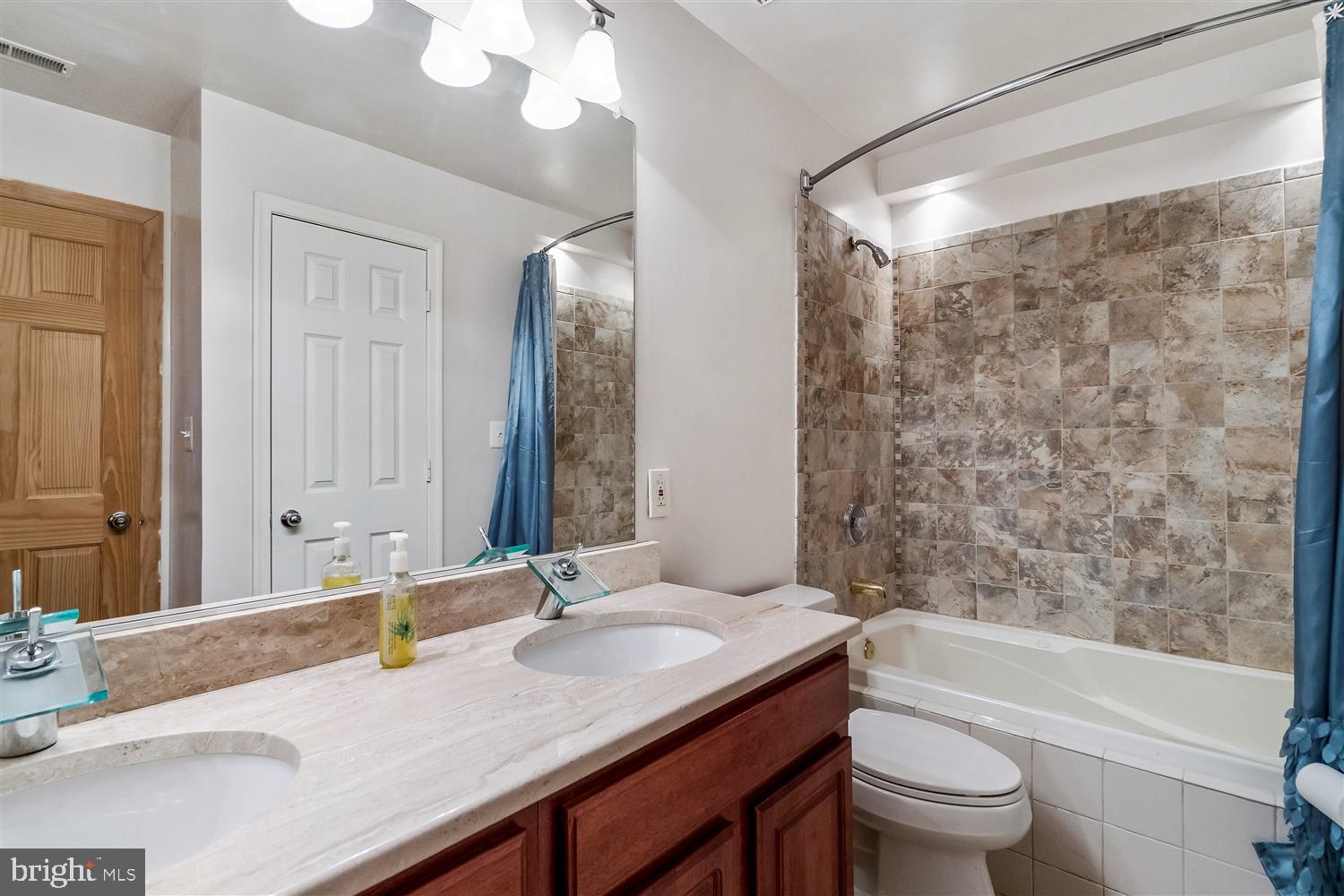 9731 Eustice Road Randallstown, MD 21133 - Photo 28 of 38 Hall bath w/dual sinks and shower/tub combo.