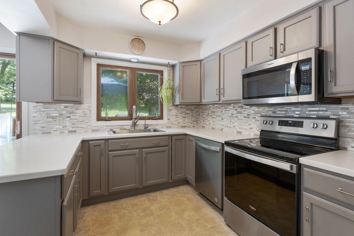 41W360 Muirhead Road Elgin, IL 60124 - Photo 6 of 32 a kitchen with stainless steel appliances a stove sink microwave and cabinets