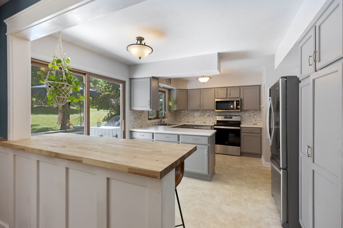 41W360 Muirhead Road Elgin, IL 60124 - Photo 8 of 32 a kitchen with refrigerator a sink and cabinets