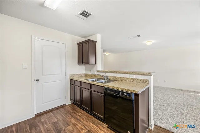a kitchen with a stove and a sink