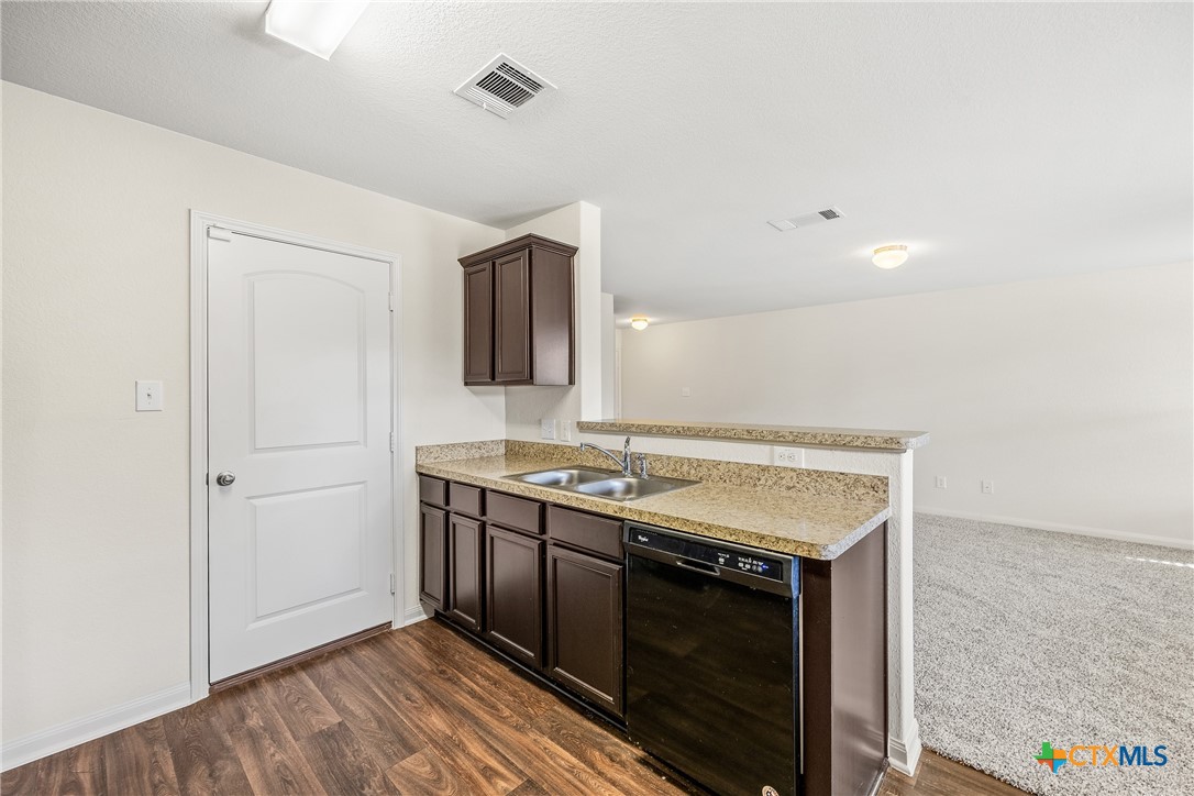 137 Bridges Lane Jarrell, TX 76537 - Photo 13 of 34 a kitchen with a stove and a sink