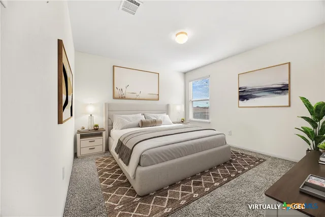 a bedroom with a bed and painting on the wall