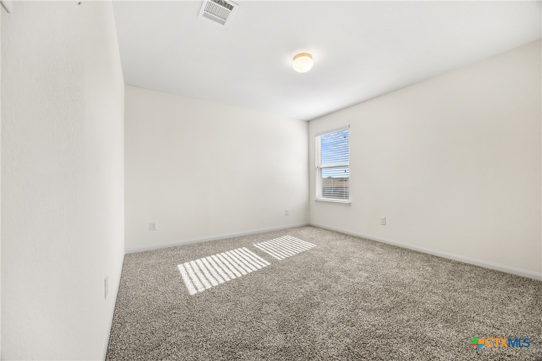 137 Bridges Lane Jarrell, TX 76537 - Photo 16 of 34 an empty room with a workbench