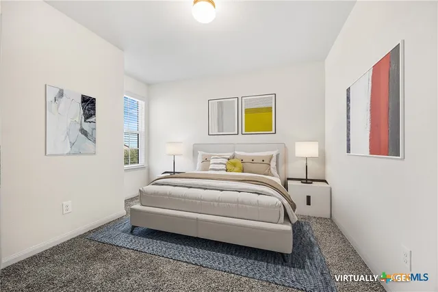 a bedroom with a bed and painting on the wall