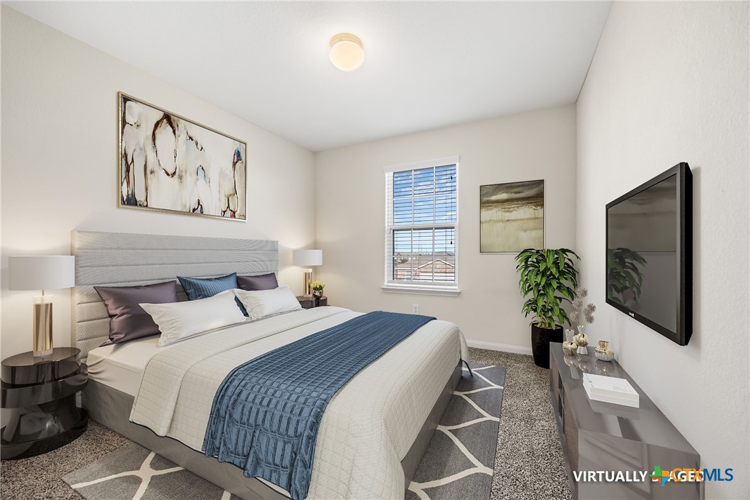 137 Bridges Lane Jarrell, TX 76537 - Photo 23 of 34 a bedroom with a bed and a flat screen tv