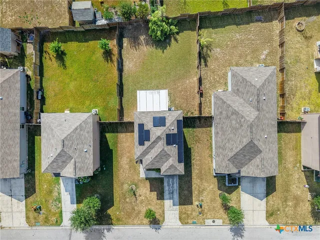 an aerial view of residential houses with outdoor space