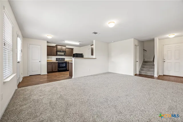 a view of a kitchen with a sink and a stove top oven