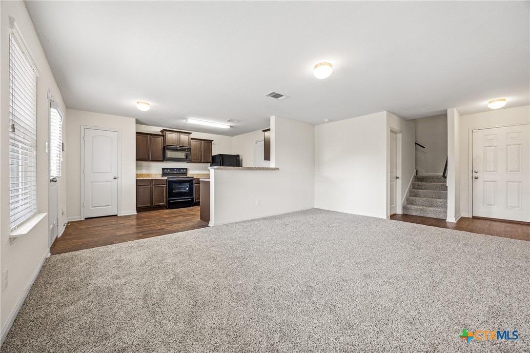 137 Bridges Lane Jarrell, TX 76537 - Photo 6 of 34 a view of a kitchen with a sink and a stove top oven