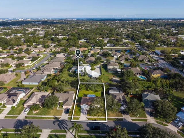 an aerial view of residential building and lake