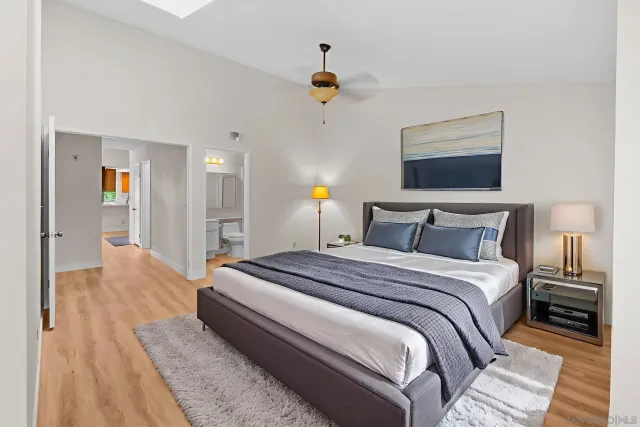 a view of empty room with wooden floor and ceiling fan