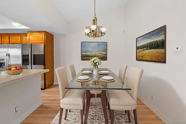 a view of a dining room with furniture wooden floor and a chandelier