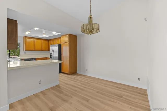 a view of a kitchen with a dishwasher and a refrigerator