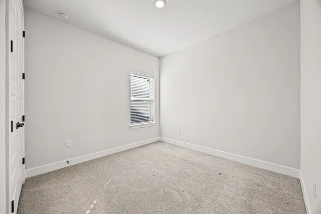 an empty room with a empty space and window