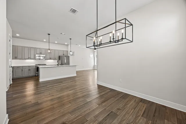a view of a kitchen and wooden floor