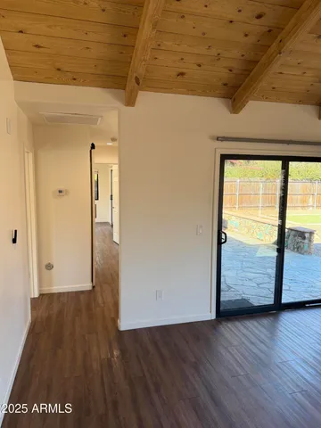 a view of hallway with wooden floor