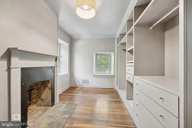 a room with a fireplace and a window