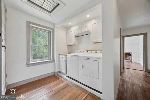 a utility room with cabinets washer and dryer