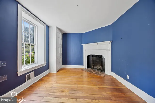 a view of a livingroom with a fireplace and window