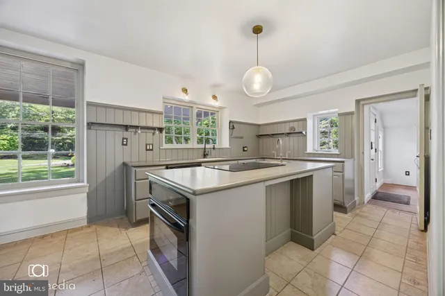 a kitchen with a sink and a stove top oven