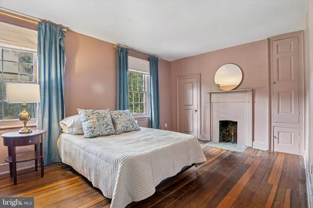 a bedroom with a bed and a fireplace