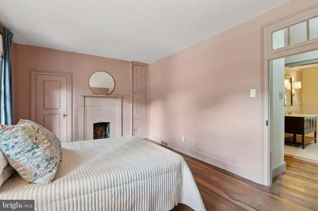 a spacious bedroom with a bed and a window