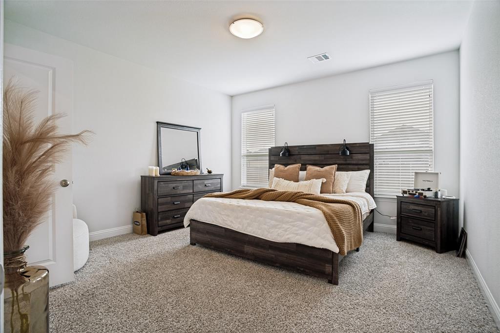 3115 Giovanni Point Princeton, TX 75407 - Photo 15 of 26 Spacious room featuring neutral carpeting, white walls, two windows with blinds, and a ceiling-mounted light fixture