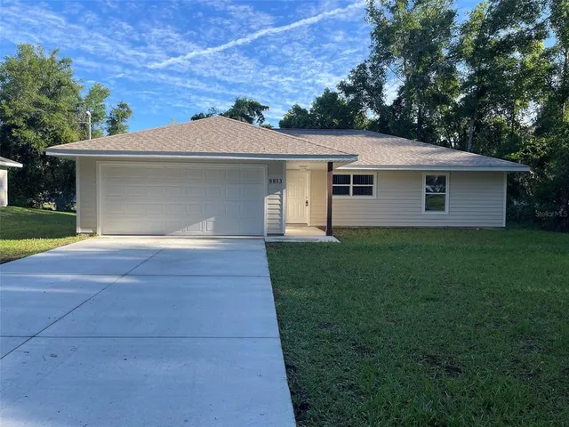 a front view of house with yard and trees
