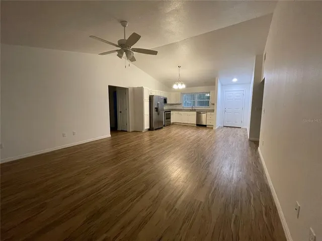 a view of a livingroom with a hardwood floor and a ceiling fan