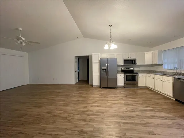 a view of a kitchen with a stove cabinets and wooden floor